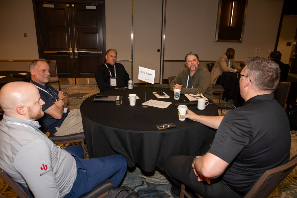 Group of people sitting around a table at a conference